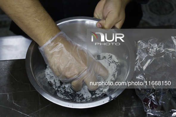 A chef mixes totomoxtle (corn husk ash) and sugar in Mexico City, Mexico, on the eve of Day of the Dead, to make Pan de Muerto. According to...