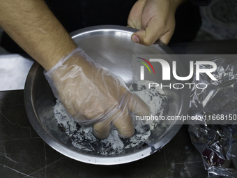 A chef mixes totomoxtle (corn husk ash) and sugar in Mexico City, Mexico, on the eve of Day of the Dead, to make Pan de Muerto. According to...