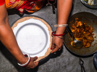 A pot of biryani, with aromatic basmati rice, cooked chicken, and a variety of spices such as saffron, kewra water, and fried onions known a...