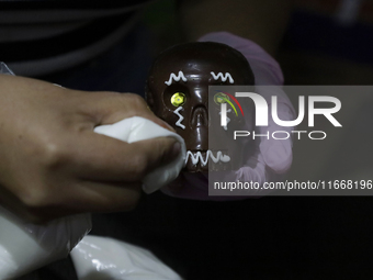 Decorated chocolate skulls are for sale in Mexico City, Mexico, on the eve of the Day of the Dead. Sugar skulls are made from alfenique, whi...