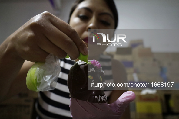 Decorated chocolate skulls are for sale in Mexico City, Mexico, on the eve of the Day of the Dead. Sugar skulls are made from alfenique, whi...