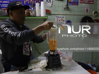 Pulque is prepared from Cempasuchil flower petals in Mexico City, Mexico, on the eve of the Day of the Dead. Pulque is an alcoholic beverage...