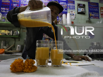 Pulque is prepared from Cempasuchil flower petals in Mexico City, Mexico, on the eve of the Day of the Dead. Pulque is an alcoholic beverage...