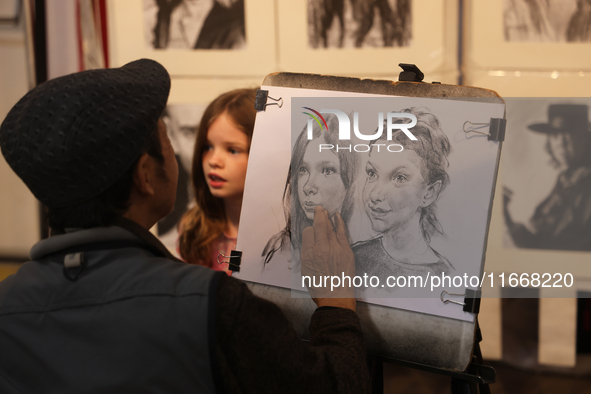 An artist sketches a little girl during the 180th annual Markham Fall Fair in Markham, Ontario, Canada, on October 5, 2024. 