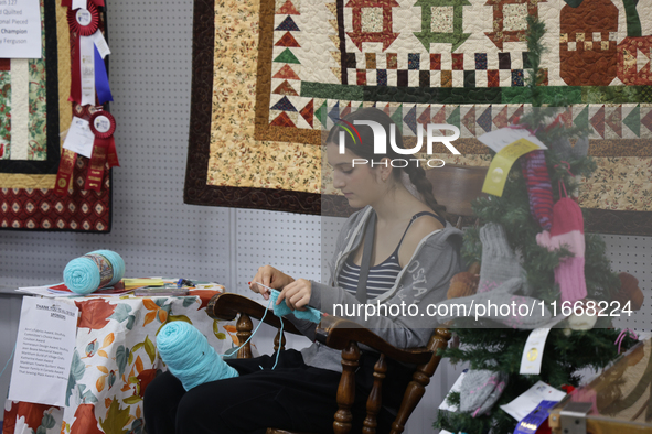 A girl crochets during the 180th annual Markham Fall Fair in Markham, Ontario, Canada, on October 5, 2024. 