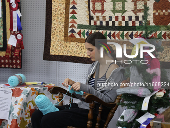 A girl crochets during the 180th annual Markham Fall Fair in Markham, Ontario, Canada, on October 5, 2024. (