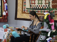 A girl crochets during the 180th annual Markham Fall Fair in Markham, Ontario, Canada, on October 5, 2024. (