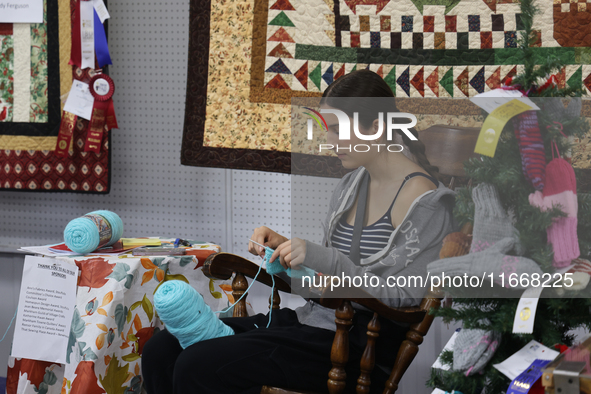 A girl crochets during the 180th annual Markham Fall Fair in Markham, Ontario, Canada, on October 5, 2024. 