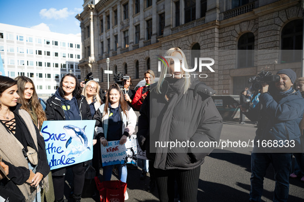 Singer Sarah Connor lies in a mini-aquarium and protests with Peta activists in front of a Tui travel agency for the release of orca whales...