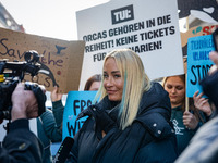 Singer Sarah Connor lies in a mini-aquarium and protests with Peta activists in front of a Tui travel agency for the release of orca whales...