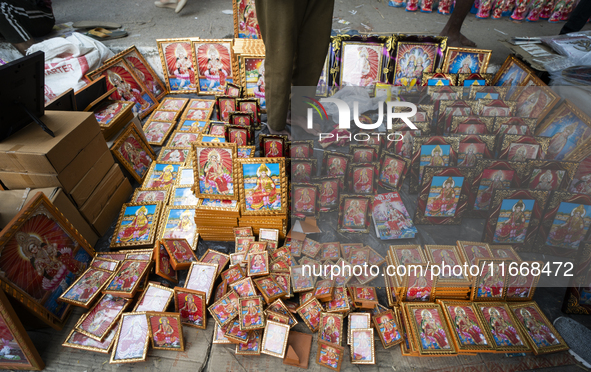 Framed Lakshmi photos are displayed for sale on the eve of the Lakshmi Puja festival in Guwahati, India, on October 15, 2024. Lakshmi is one...