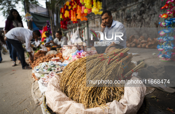 A vendor sells decorative paddy bunches on the eve of the Lakshmi Puja festival in Guwahati, India, on October 15, 2024. Lakshmi is one of t...