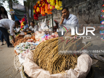 A vendor sells decorative paddy bunches on the eve of the Lakshmi Puja festival in Guwahati, India, on October 15, 2024. Lakshmi is one of t...