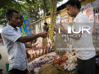 A vendor sells decorative paddy bunches on the eve of the Lakshmi Puja festival in Guwahati, India, on October 15, 2024. Lakshmi is one of t...