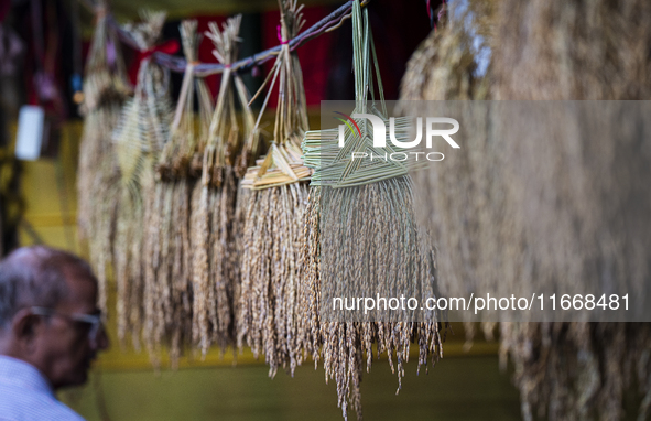 A vendor sells decorative paddy bunches on the eve of the Lakshmi Puja festival in Guwahati, India, on October 15, 2024. Lakshmi is one of t...