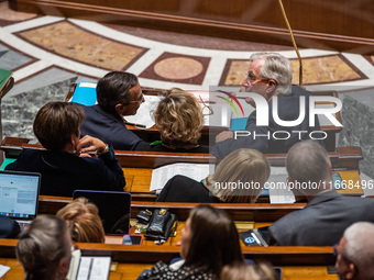 Prime Minister Michel Barnier is at the National Assembly alongside Interior Minister Bruno Retailleau (left) and Nathalie Delattre, Ministe...