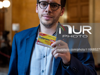 La France Insoumise deputy Hadrien Clouet shows a packet of Doliprane, the best-selling drug in France, at the center of controversy over th...