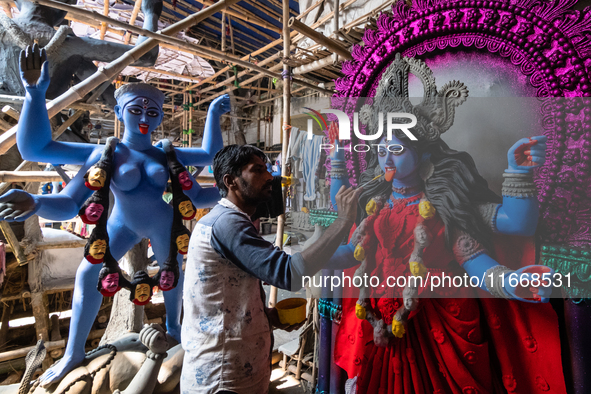 An artist makes final touches to a Hindu Goddess Kali statue for the upcoming Diwali festival at a workshop in Kolkata, India. Diwali is one...