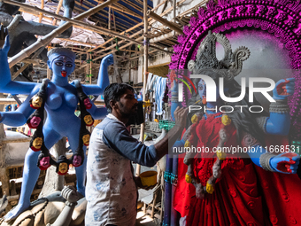 An artist makes final touches to a Hindu Goddess Kali statue for the upcoming Diwali festival at a workshop in Kolkata, India. Diwali is one...