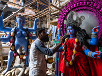 An artist makes final touches to a Hindu Goddess Kali statue for the upcoming Diwali festival at a workshop in Kolkata, India. Diwali is one...