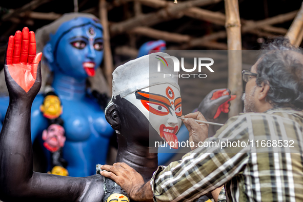 An artist makes final touches to a Hindu Goddess Kali statue for the upcoming Diwali festival at a workshop in Kolkata, India. Diwali is one...