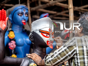 An artist makes final touches to a Hindu Goddess Kali statue for the upcoming Diwali festival at a workshop in Kolkata, India. Diwali is one...