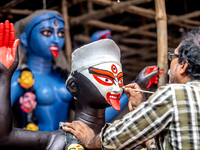 An artist makes final touches to a Hindu Goddess Kali statue for the upcoming Diwali festival at a workshop in Kolkata, India. Diwali is one...