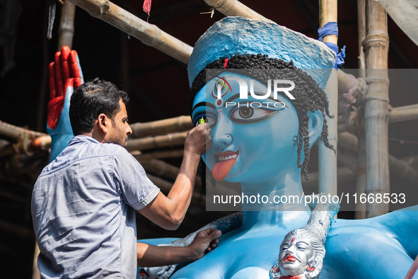 An artist makes final touches to a Hindu Goddess Kali statue for the upcoming Diwali festival at a workshop in Kolkata, India. Diwali is one...