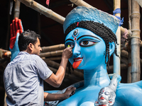 An artist makes final touches to a Hindu Goddess Kali statue for the upcoming Diwali festival at a workshop in Kolkata, India. Diwali is one...