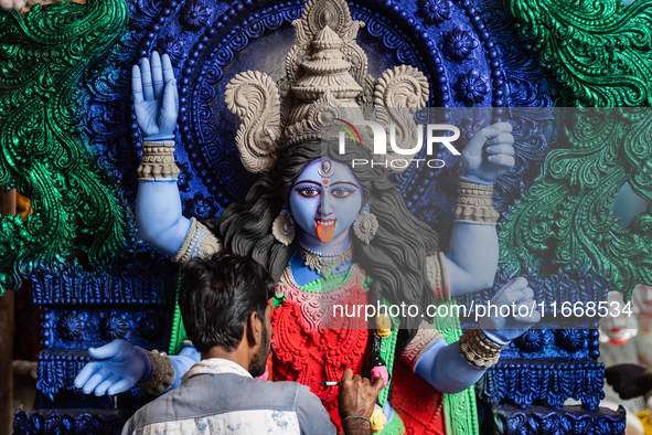 An artist makes final touches to a Hindu Goddess Kali statue for the upcoming Diwali festival at a workshop in Kolkata, India. Diwali is one...