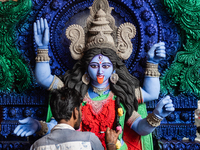 An artist makes final touches to a Hindu Goddess Kali statue for the upcoming Diwali festival at a workshop in Kolkata, India. Diwali is one...