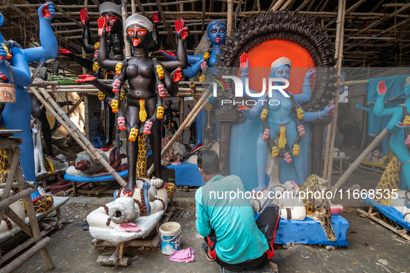 An artist makes final touches to a Hindu Goddess Kali statue for the upcoming Diwali festival at a workshop in Kolkata, India. Diwali is one...