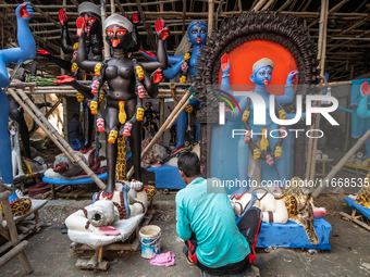 An artist makes final touches to a Hindu Goddess Kali statue for the upcoming Diwali festival at a workshop in Kolkata, India. Diwali is one...