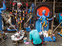 An artist makes final touches to a Hindu Goddess Kali statue for the upcoming Diwali festival at a workshop in Kolkata, India. Diwali is one...