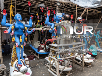 An artist makes final touches to a Hindu Goddess Kali statue for the upcoming Diwali festival at a workshop in Kolkata, India. Diwali is one...