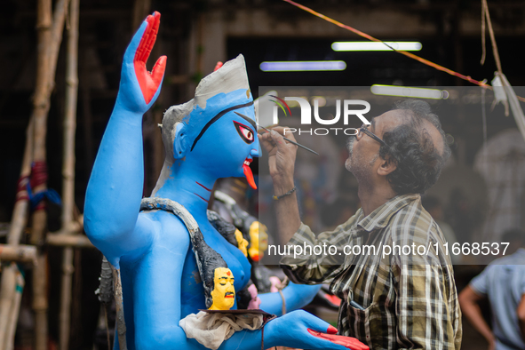 An artist makes final touches to a Hindu Goddess Kali statue for the upcoming Diwali festival at a workshop in Kolkata, India. Diwali is one...