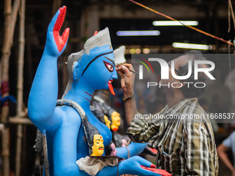 An artist makes final touches to a Hindu Goddess Kali statue for the upcoming Diwali festival at a workshop in Kolkata, India. Diwali is one...