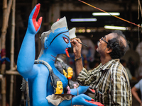 An artist makes final touches to a Hindu Goddess Kali statue for the upcoming Diwali festival at a workshop in Kolkata, India. Diwali is one...