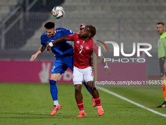 Oleg Reabciuk of Moldova vies for the ball with Joseph Mbong of Malta during the UEFA Nations League, League D, Group D2 soccer match betwee...