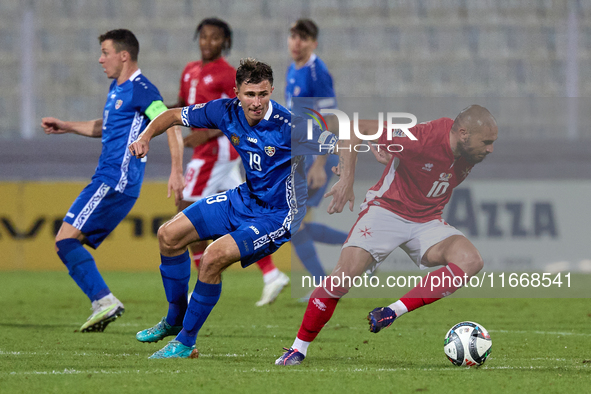 Teddy Teuma of Malta moves away with the ball from Dmitri Mandricenco of Moldova during the UEFA Nations League, League D, Group D2 soccer m...