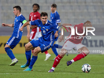 Teddy Teuma of Malta moves away with the ball from Dmitri Mandricenco of Moldova during the UEFA Nations League, League D, Group D2 soccer m...