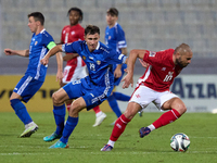 Teddy Teuma of Malta moves away with the ball from Dmitri Mandricenco of Moldova during the UEFA Nations League, League D, Group D2 soccer m...