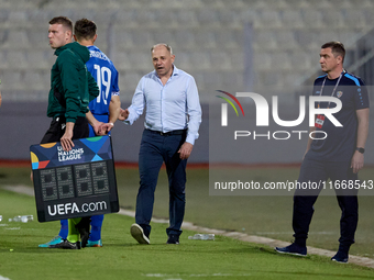 In Ta' Qali, Malta, on October 13, 2024, Serghei Clescenco, head coach of Moldova, speaks to Dmitri Mandricenco before a substitution during...