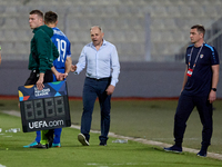 In Ta' Qali, Malta, on October 13, 2024, Serghei Clescenco, head coach of Moldova, speaks to Dmitri Mandricenco before a substitution during...