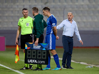 In Ta' Qali, Malta, on October 13, 2024, Serghei Clescenco, head coach of Moldova, speaks to Dmitri Mandricenco before a substitution during...