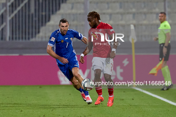 Joseph Mbong of Malta is closely followed by Artur Ionita of Moldova during the UEFA Nations League, League D, Group D2 soccer match between...