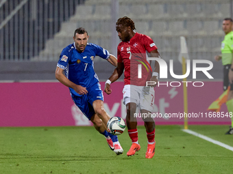 Joseph Mbong of Malta is closely followed by Artur Ionita of Moldova during the UEFA Nations League, League D, Group D2 soccer match between...