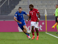 Joseph Mbong of Malta is closely followed by Artur Ionita of Moldova during the UEFA Nations League, League D, Group D2 soccer match between...