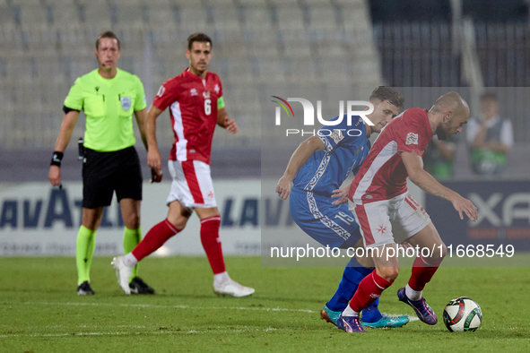 In Ta' Qali, Malta, on October 13, 2024, Teddy Teuma of Malta moves away with the ball from Dmitri Mandricenco of Moldova during the UEFA Na...