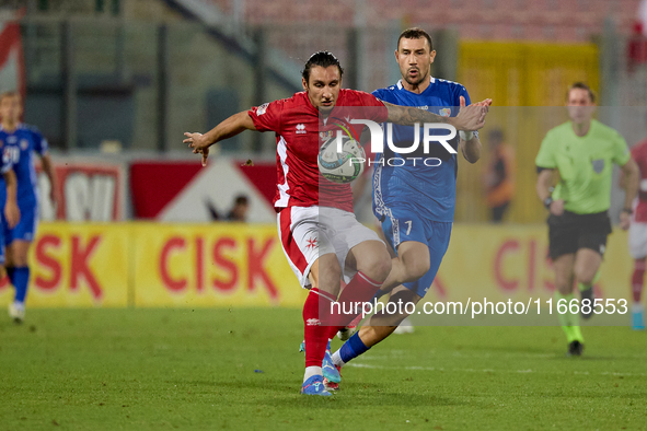 In Ta' Qali, Malta, on October 13, 2024, Kurt Shaw of Malta protects the ball from Artur Ionita of Moldova during the UEFA Nations League, L...